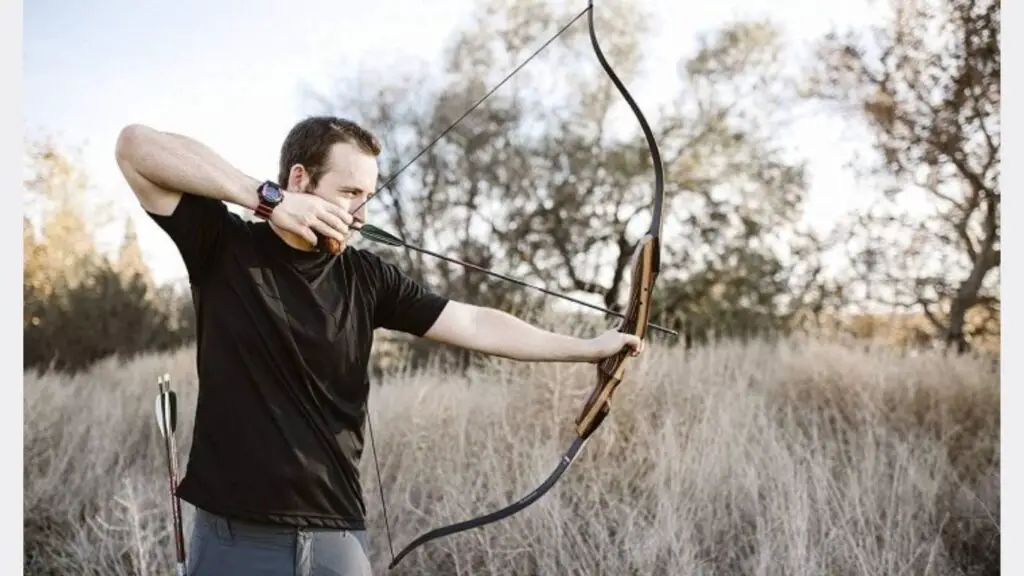 A man aiming a target as traditional archery