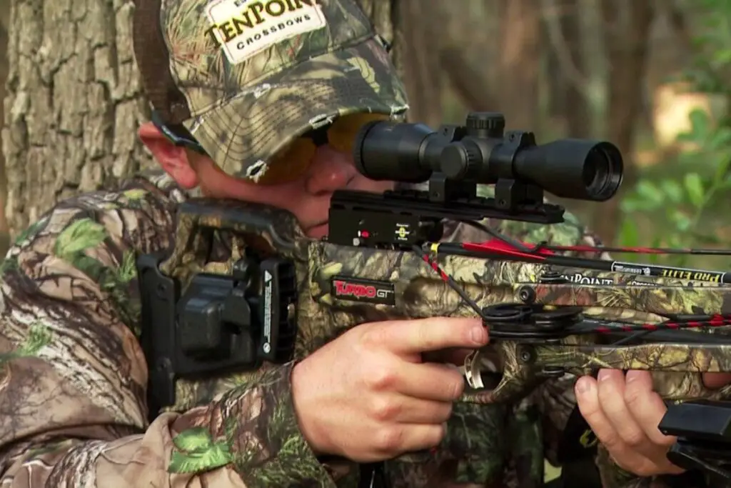 A Hunter is Sighting in a crossbow for perfect shooting